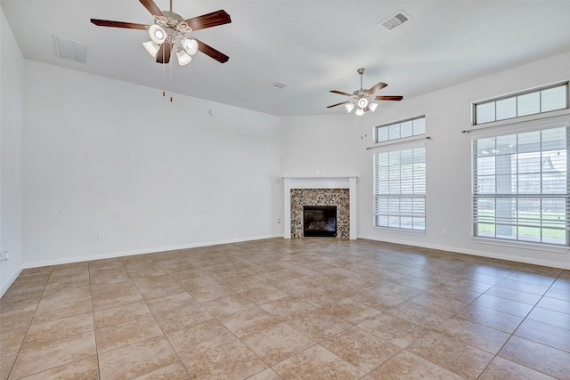 6722 Hawkins St, Manvel, TX 77578 - unfurnished living room with ceiling fan, light tile patterned floors, a fireplace, baseboards, and a high ceiling