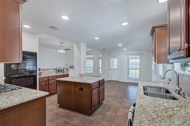 6722 Hawkins St, Manvel, TX 77578 - kitchen featuring a sink, black appliances, a ceiling fan, tasteful backsplash, and light tile patterned flooring