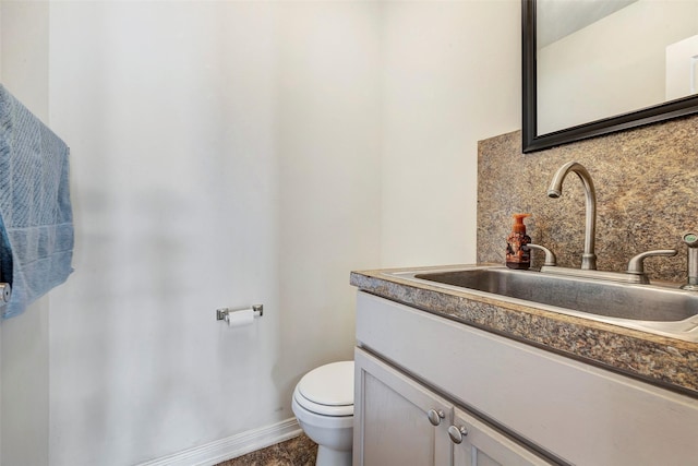 6722 Hawkins St, Manvel, TX 77578 - half bathroom with toilet, backsplash, vanity, and baseboards