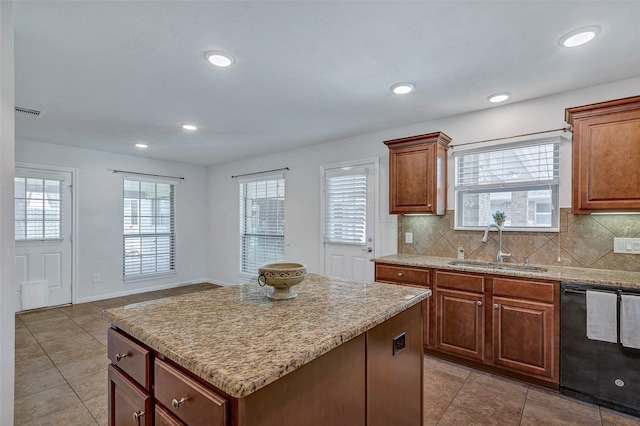 6722 Hawkins St, Manvel, TX 77578 - kitchen featuring dishwasher, a sink, light tile patterned flooring, backsplash, and a center island