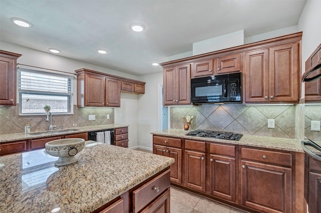 6722 Hawkins St, Manvel, TX 77578 - kitchen featuring black appliances, a sink, light stone counters, tasteful backsplash, and recessed lighting