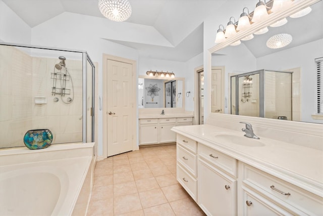44 Westchester Dr, Conroe, TX 77304 - full bathroom with a stall shower, lofted ceiling, tile patterned floors, a bath, and two vanities