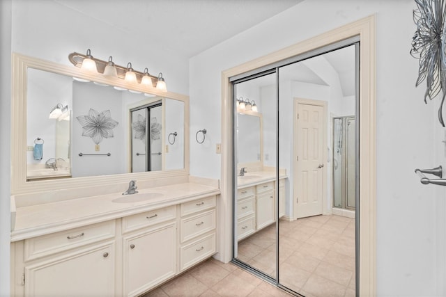 44 Westchester Dr, Conroe, TX 77304 - full bathroom featuring two vanities, a shower stall, and tile patterned flooring