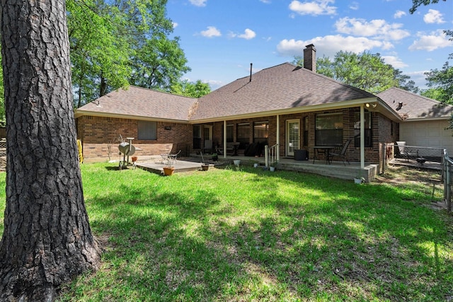 44 Westchester Dr, Conroe, TX 77304 - rear view of property featuring a chimney, a patio, brick siding, a garage, and roof with shingles