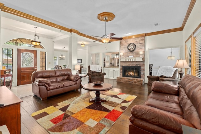44 Westchester Dr, Conroe, TX 77304 - living area featuring hardwood / wood-style flooring, crown molding, ceiling fan, and a brick fireplace