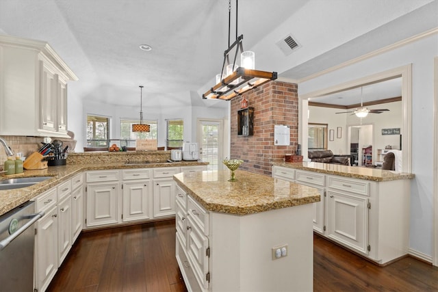 44 Westchester Dr, Conroe, TX 77304 - kitchen featuring a sink, a peninsula, stainless steel dishwasher, dark wood finished floors, and decorative backsplash