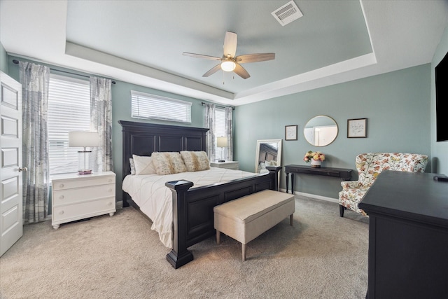 10407 Quiet Courtyard Rd, Houston, TX 77043 - bedroom with a raised ceiling, light colored carpet, a ceiling fan, and baseboards