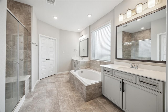10407 Quiet Courtyard Rd, Houston, TX 77043 - bathroom featuring a stall shower, a garden tub, two vanities, baseboards, and recessed lighting