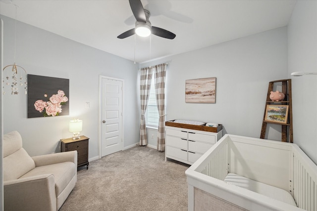 10407 Quiet Courtyard Rd, Houston, TX 77043 - bedroom featuring a nursery area, light carpet, ceiling fan, and baseboards