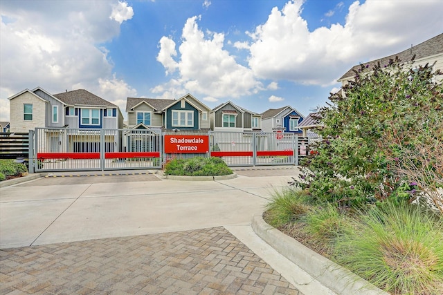 10407 Quiet Courtyard Rd, Houston, TX 77043 - view of community with a residential view, a fenced front yard, driveway, and a gate