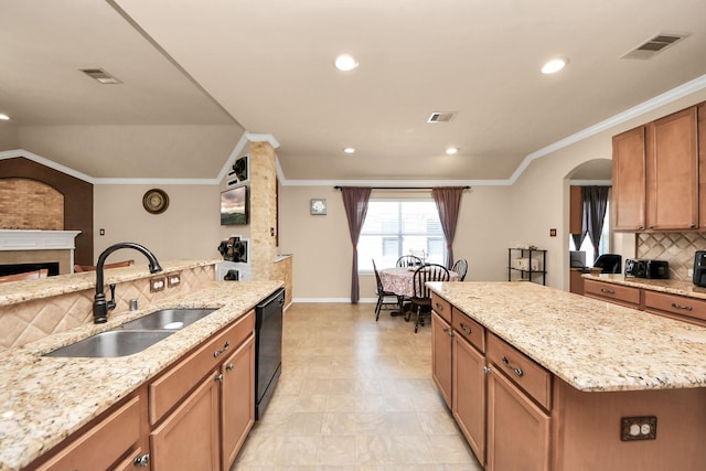11126 E Lake Gables Dr, Richmond, TX 77406 - kitchen with a sink, dishwasher, backsplash, a fireplace, and light stone counters