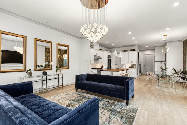 living room featuring a chandelier, light wood-style floors, crown molding, recessed lighting, and baseboards
