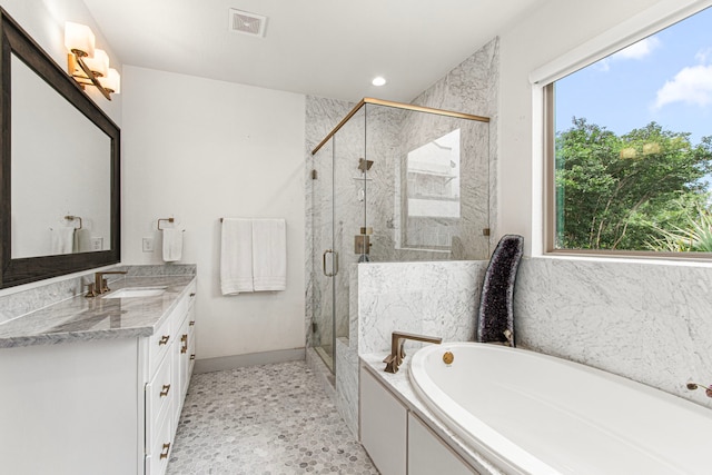 bathroom featuring a bath, vanity, a marble finish shower, recessed lighting, and baseboards