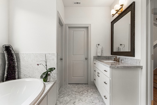 full bathroom featuring vanity and a bath