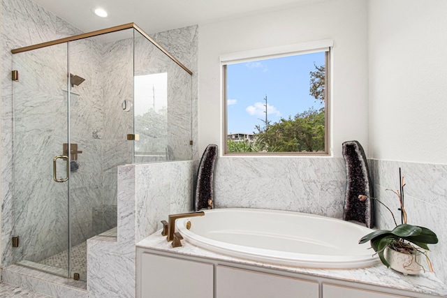 full bath with a bath, a marble finish shower, and recessed lighting