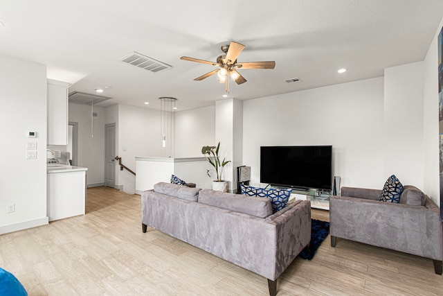 living room featuring attic access, ceiling fan, light wood-type flooring, recessed lighting, and baseboards