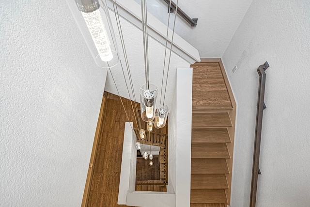 stairs featuring a textured wall