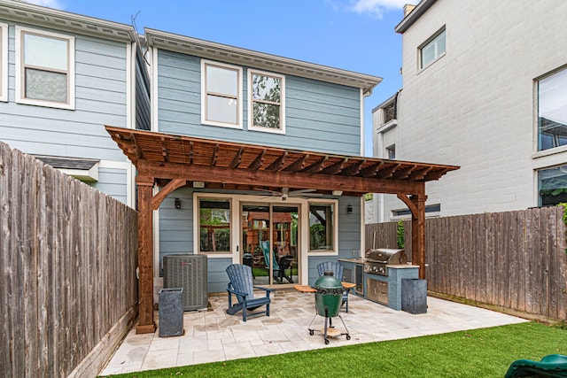 back of property featuring exterior kitchen, a ceiling fan, central AC unit, and a patio area