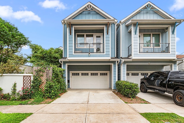 view of front of home with a garage, board and batten siding, a balcony, and driveway