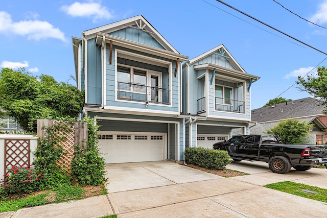 view of front of home with an attached garage, board and batten siding, a balcony, and driveway