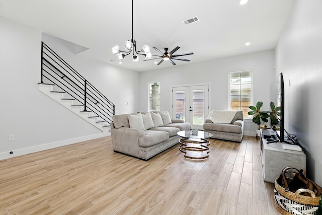 5209 Canal St, Houston, TX 77011 - living room featuring light wood-style flooring, stairway, french doors, recessed lighting, and a chandelier
