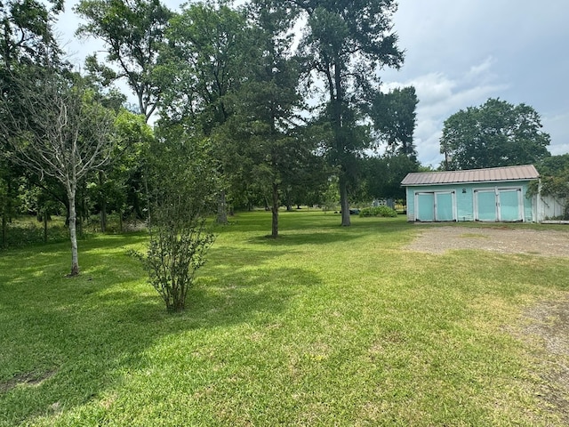 12215 Fm 442nd Rd, Boling, TX 77420 - view of grassy yard featuring a detached garage and an outdoor structure