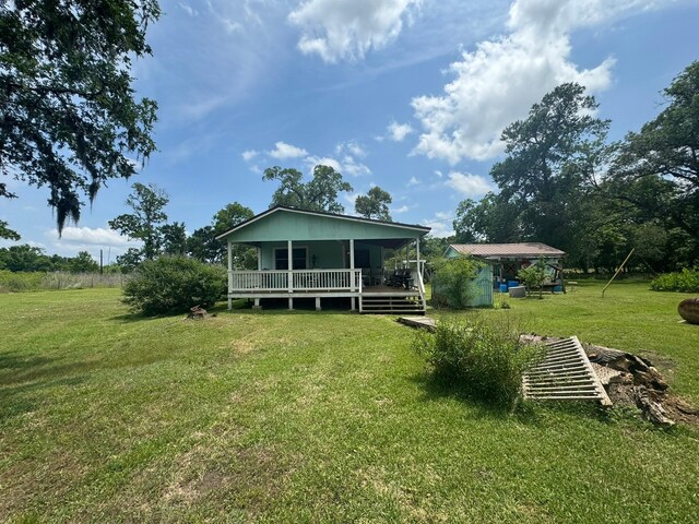 12215 Fm 442nd Rd, Boling, TX 77420 - rear view of property with a yard and a porch