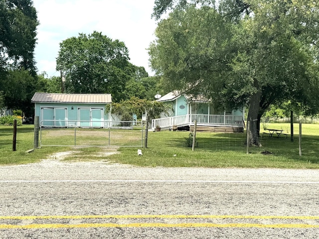 12215 Fm 442nd Rd, Boling, TX 77420 - view of property hidden behind natural elements featuring driveway, an outbuilding, and metal roof