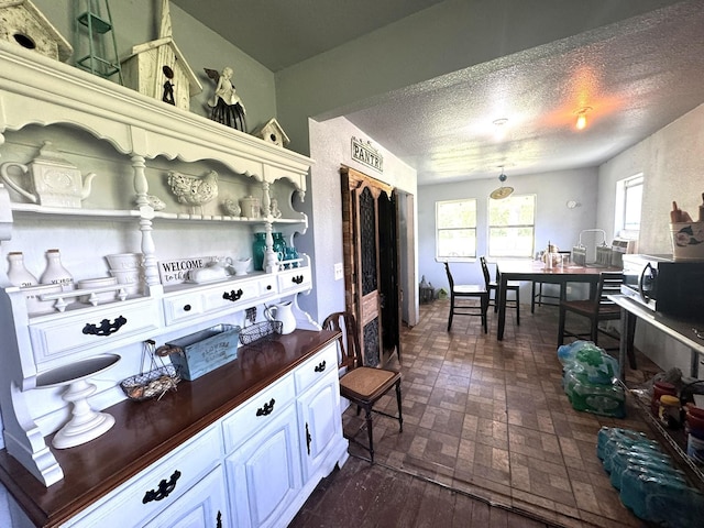 12215 Fm 442nd Rd, Boling, TX 77420 - kitchen with butcher block counters, brick patterned flooring, a textured ceiling, and open shelves