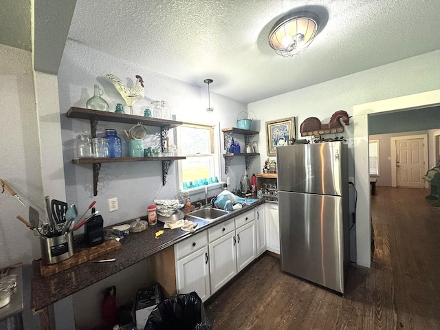 12215 Fm 442nd Rd, Boling, TX 77420 - kitchen featuring freestanding refrigerator, dark countertops, open shelves, dark wood finished floors, and white cabinetry
