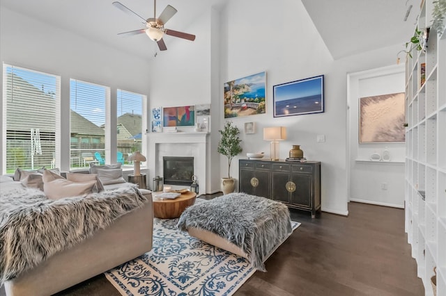 2824 Jehlon Ln, Conroe, TX 77385 - living room with high vaulted ceiling, ceiling fan, dark wood-style floors, and a glass covered fireplace