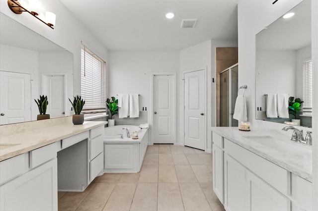 2824 Jehlon Ln, Conroe, TX 77385 - bathroom with a stall shower, plenty of natural light, two vanities, and recessed lighting