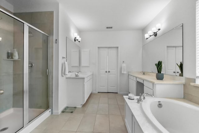 2824 Jehlon Ln, Conroe, TX 77385 - full bathroom featuring tile patterned floors, a shower stall, a garden tub, vanity, and baseboards