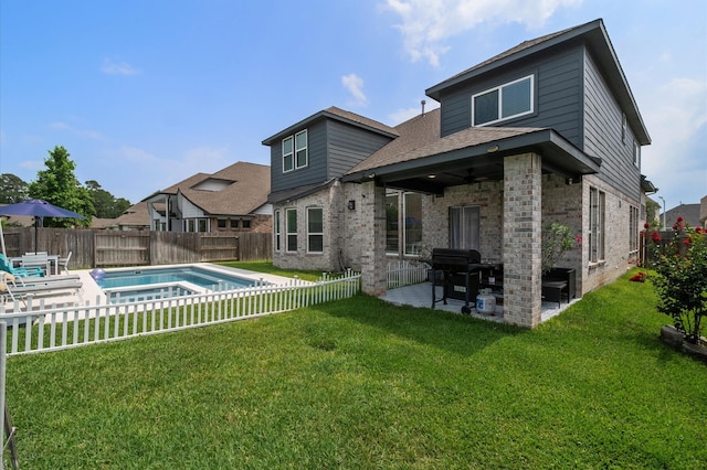2824 Jehlon Ln, Conroe, TX 77385 - back of property featuring a patio area, brick siding, and roof with shingles