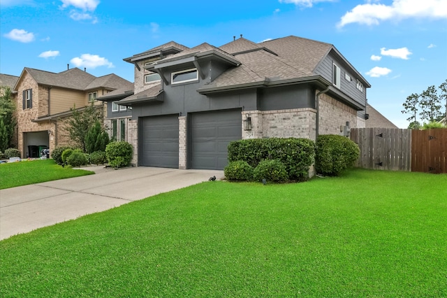 2824 Jehlon Ln, Conroe, TX 77385 - view of front of property featuring concrete driveway, roof with shingles, brick siding, a garage, and stucco siding