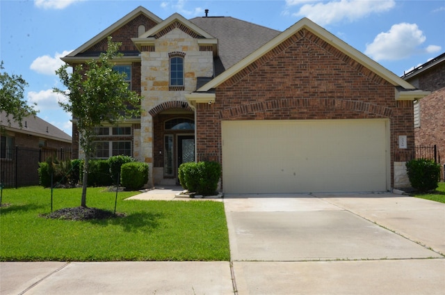 french country style house with brick siding, an attached garage, driveway, and stone siding