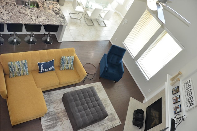 living room featuring wood finished floors and a ceiling fan