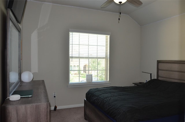 bedroom with carpet floors, baseboards, and vaulted ceiling