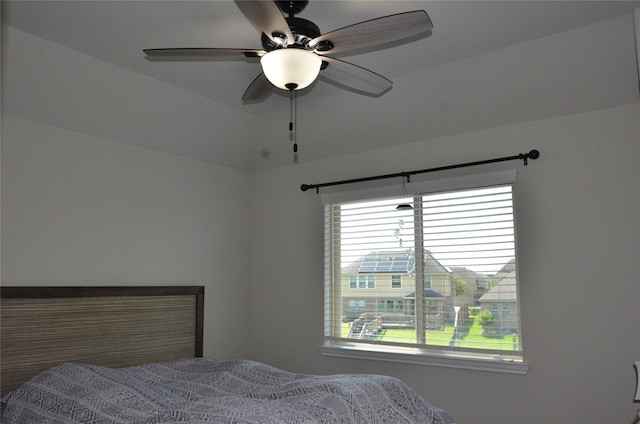 bedroom with multiple windows and ceiling fan