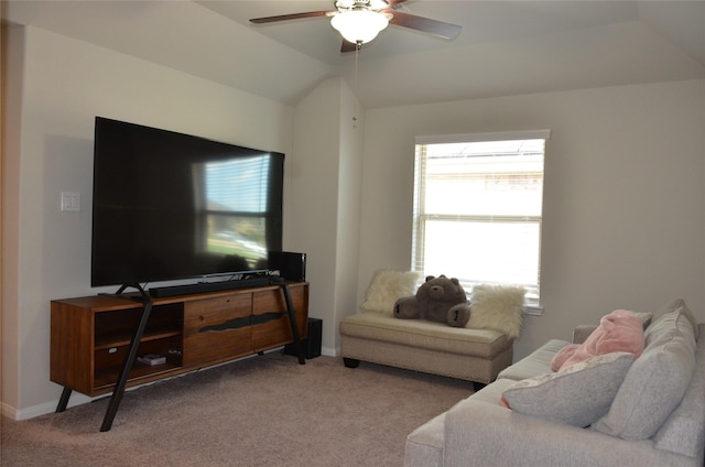 carpeted living area with a ceiling fan, vaulted ceiling, and baseboards
