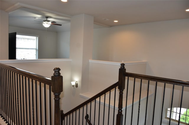 stairway with a ceiling fan and recessed lighting