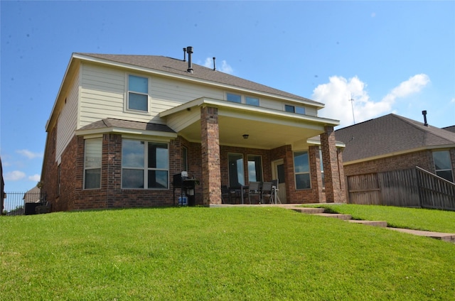back of property featuring brick siding and a patio