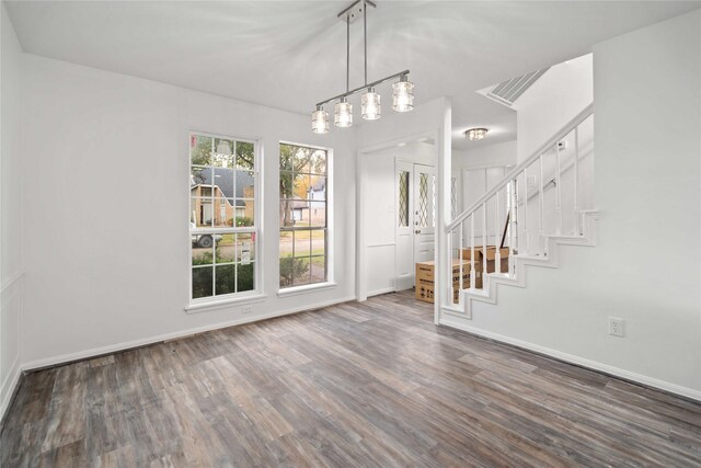 6719 Brittany Park Ln, Houston, TX 77066 - unfurnished dining area with wood finished floors, baseboards, and stairway