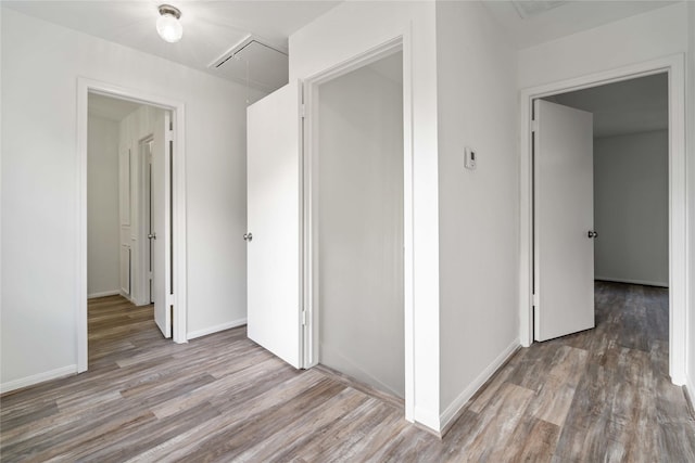 6719 Brittany Park Ln, Houston, TX 77066 - corridor with attic access, wood finished floors, and baseboards