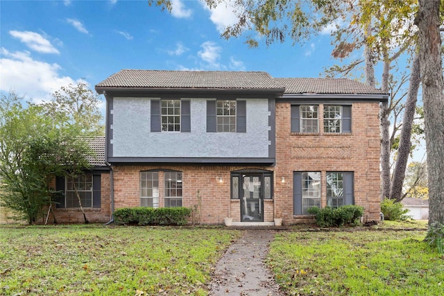 6719 Brittany Park Ln, Houston, TX 77066 - view of front facade with a tile roof, a front yard, and stucco siding