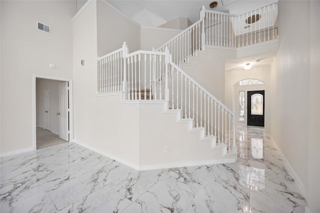 1910 Shark Ct, Crosby, TX 77532 - foyer entrance with a towering ceiling, stairway, marble tiled flooring, and baseboards