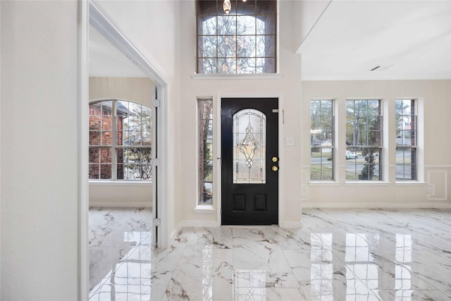1910 Shark Ct, Crosby, TX 77532 - foyer entrance featuring healthy amount of natural light, marble tiled flooring, baseboards, and a high ceiling