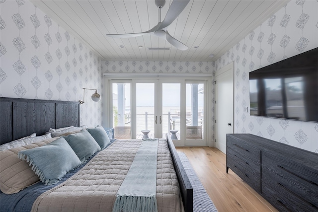 1311 Oahu Dr, Tiki Island, TX 77554 - bedroom featuring wallpapered walls, access to outside, wood ceiling, light wood finished floors, and a ceiling fan