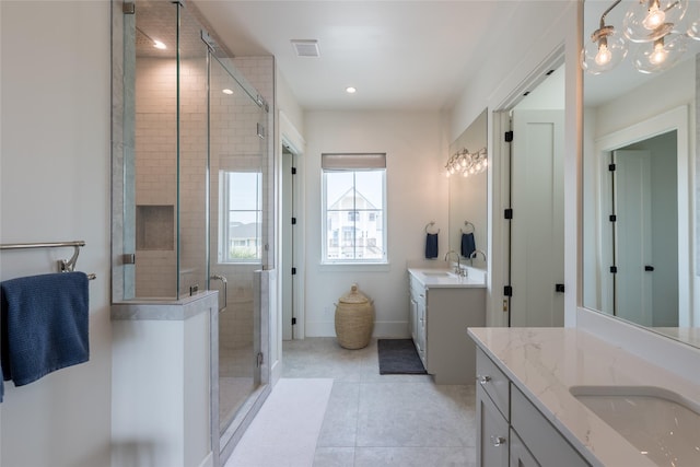 1311 Oahu Dr, Tiki Island, TX 77554 - full bathroom with a shower stall, two vanities, tile patterned floors, recessed lighting, and baseboards