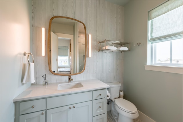 1311 Oahu Dr, Tiki Island, TX 77554 - bathroom featuring toilet, vanity, and baseboards